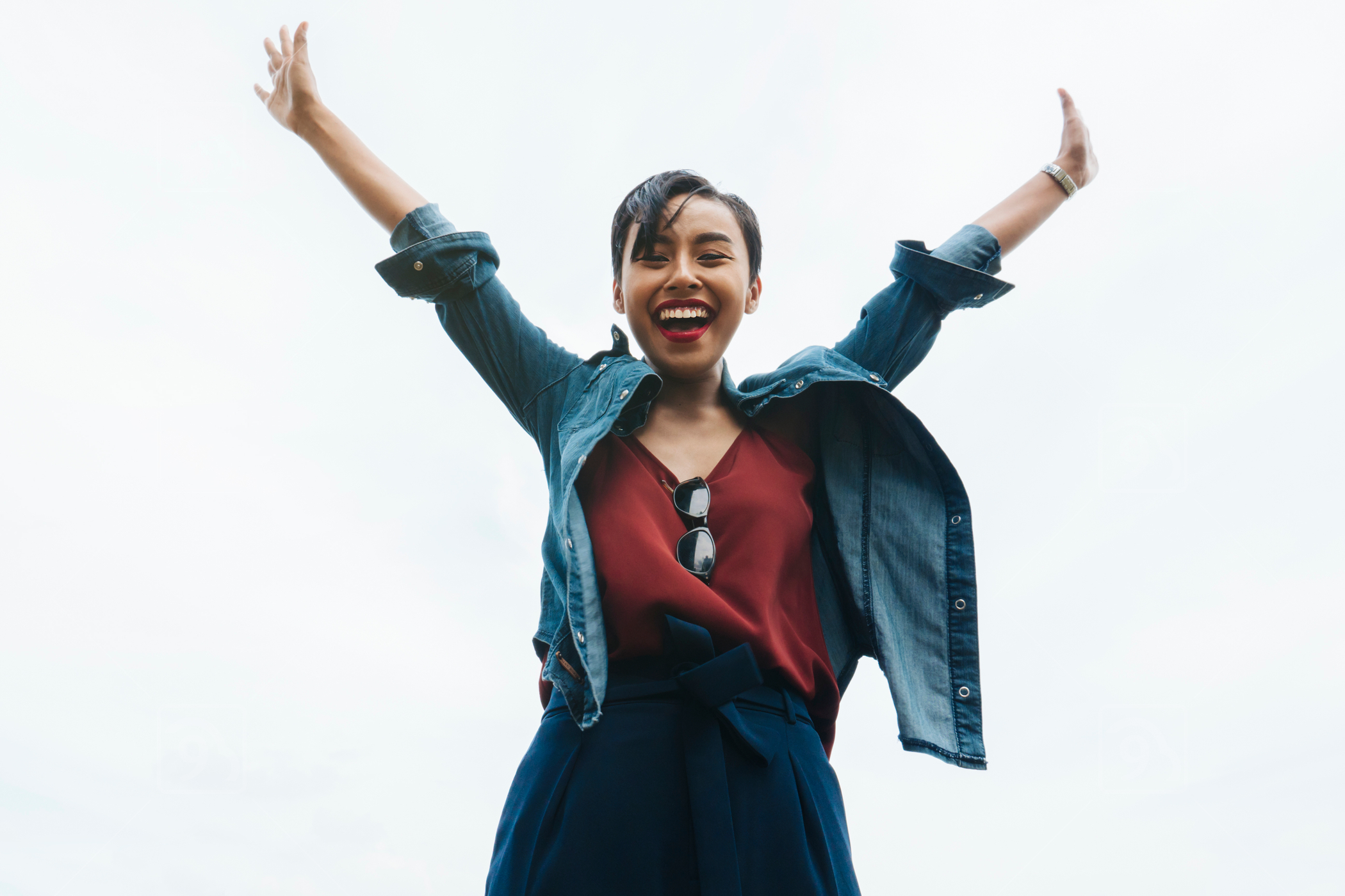 Extremely Happy Young Malay Lady Waving Both Of Her Arms In The Air 