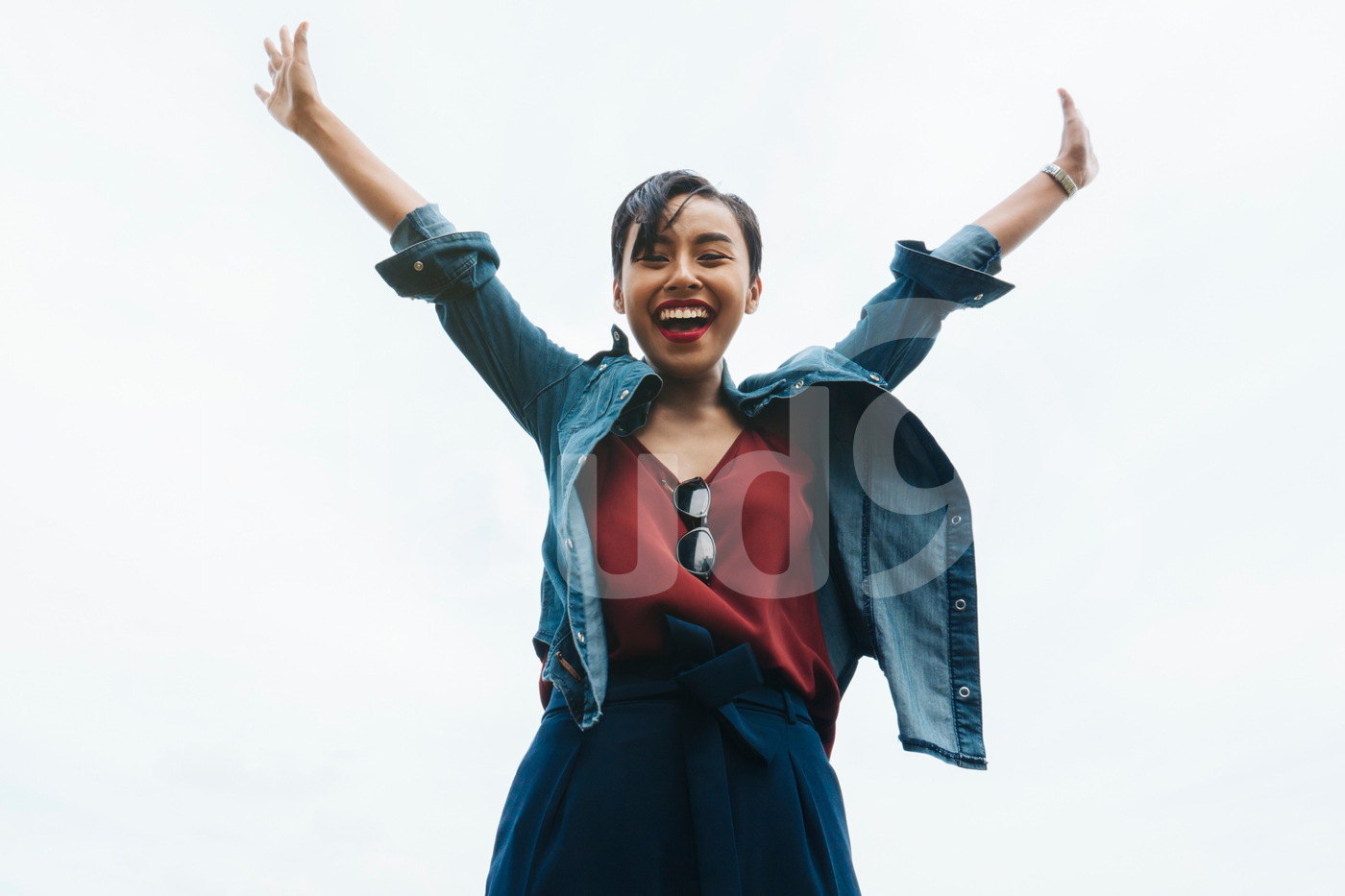 Extremely Happy Young Malay Lady Waving Both Of Her Arms In The Air