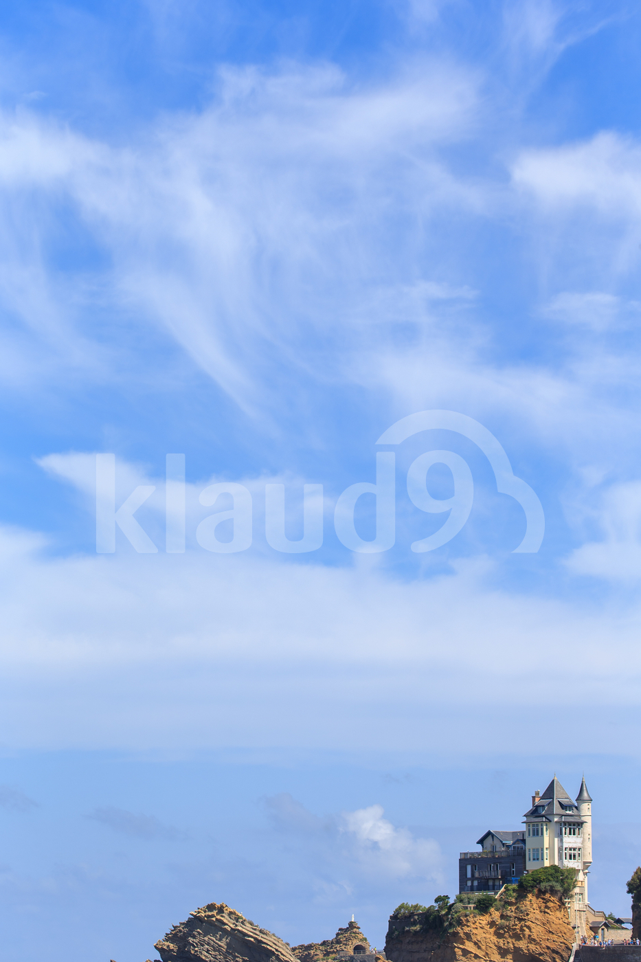 Villa on Rock with Blue Sky and Clouds