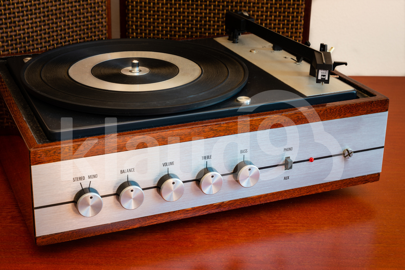 Vintage turntable made of wood with speakers on a old table