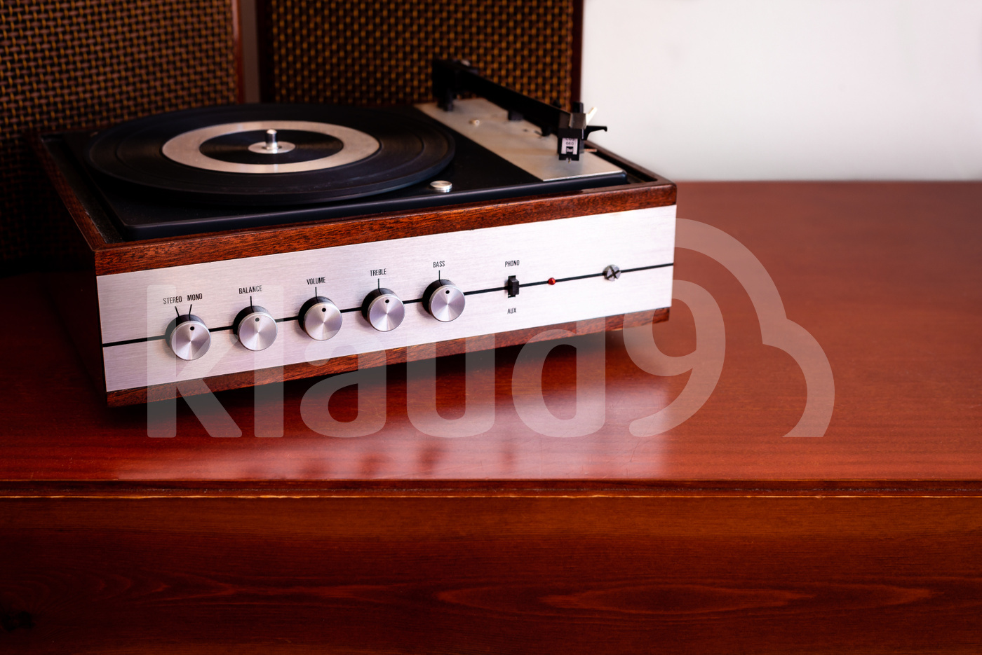 Vintage turntable made of wood with speakers on a old table