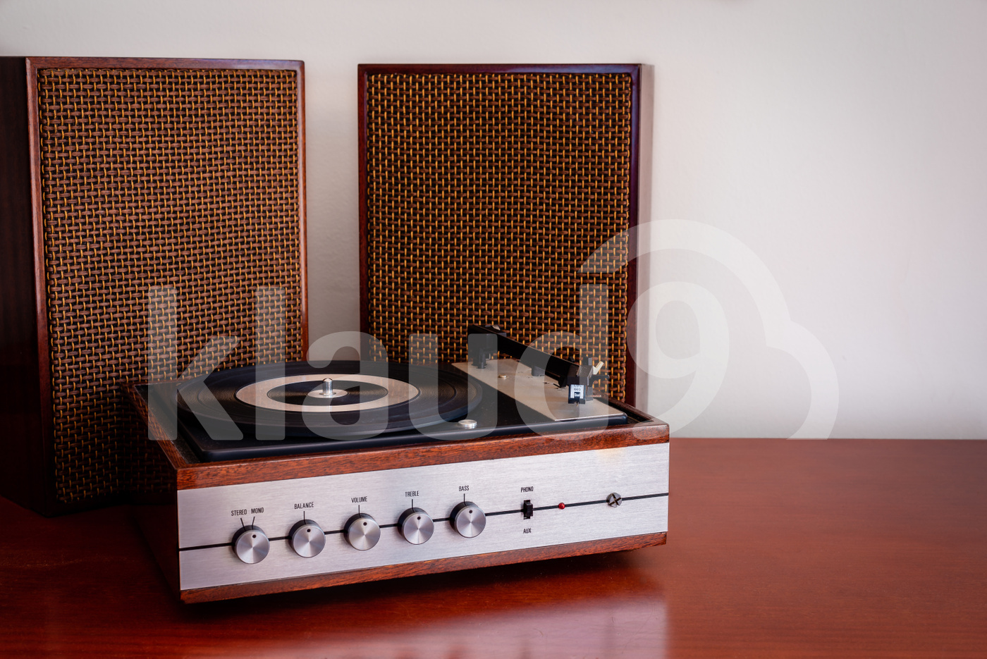 Vintage turntable made of wood with speakers on a old table