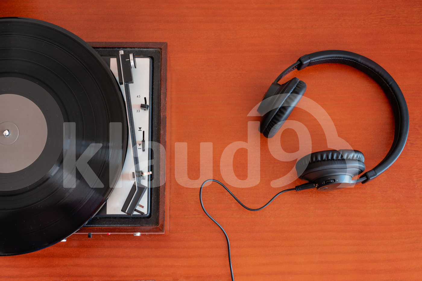 Vintage turntable, headphones and vinyl on a old table 