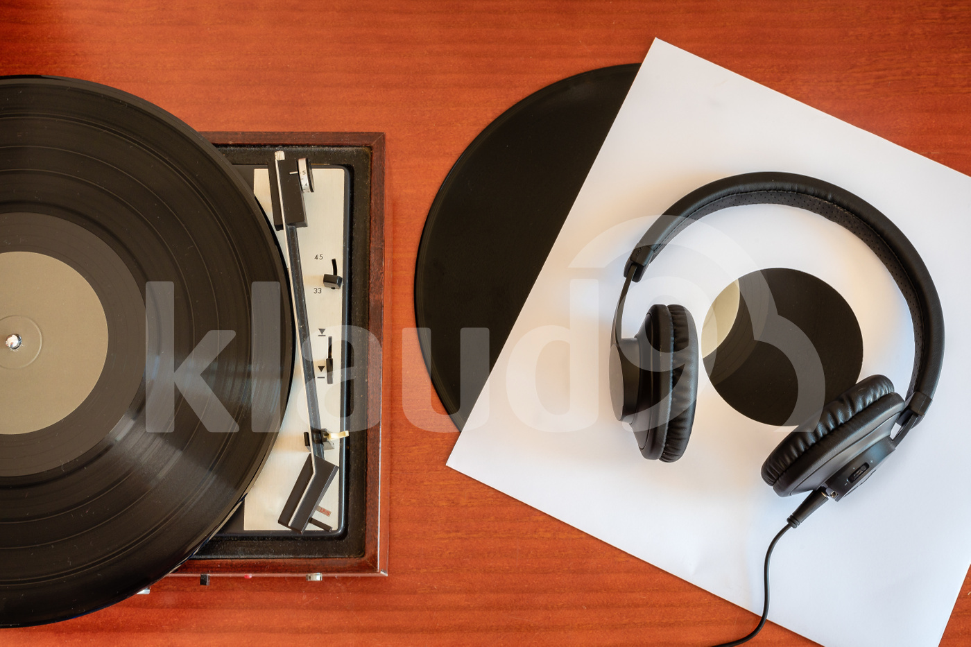 Vintage turntable, headphones and vinyls on a old table 