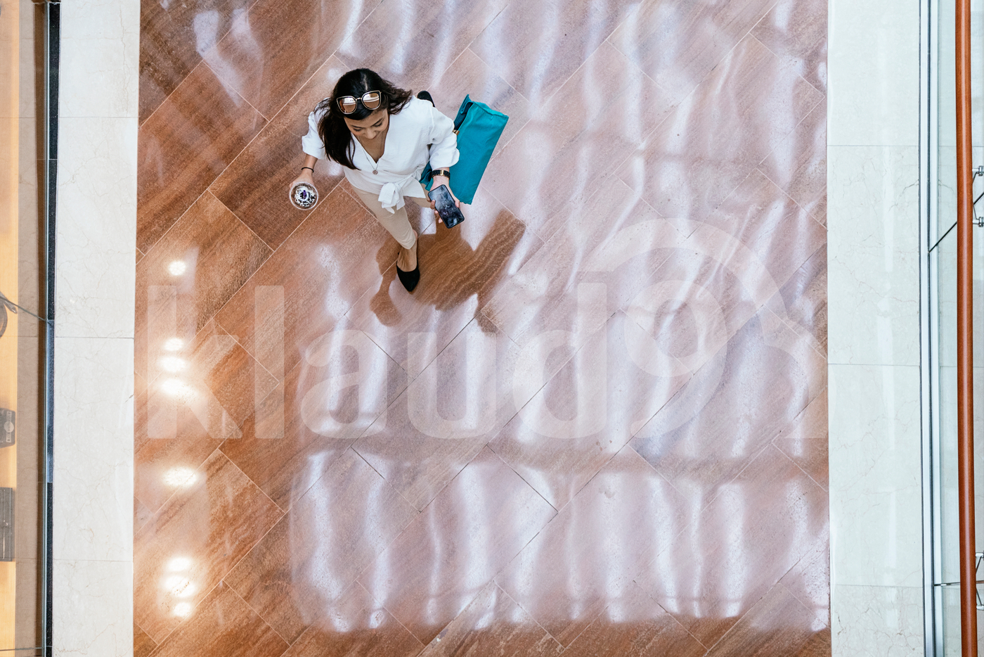 Aerial view of woman walking down the mall