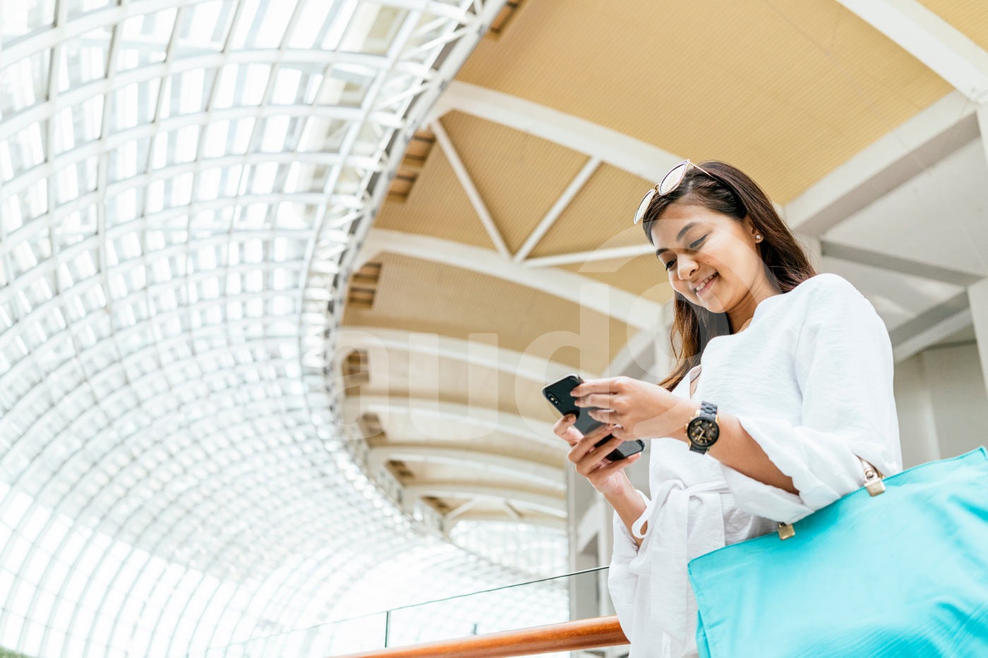 Woman standing in the mall using a mobile