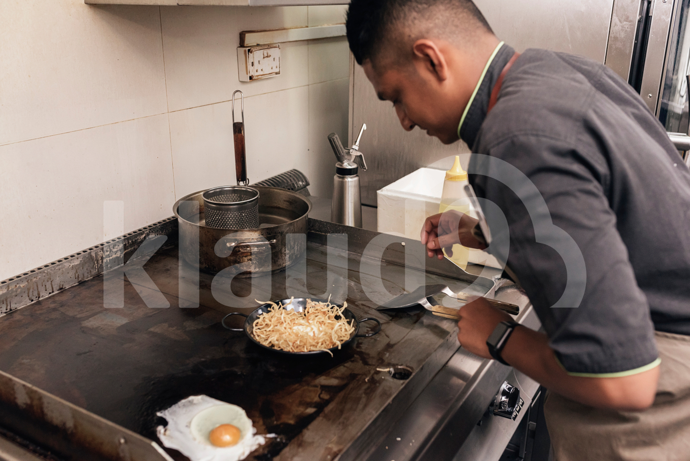 Asian chef preparing food in the restaurant kitchen