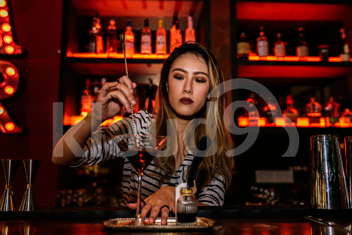 Asian bartender preparing a cocktail