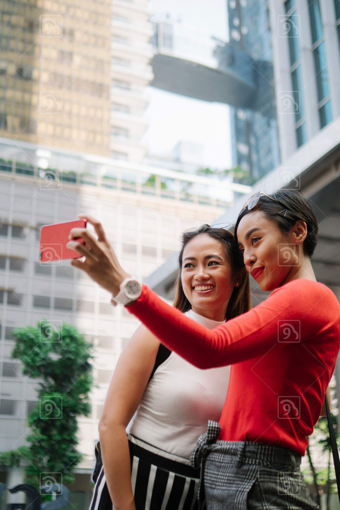 Millennial Asians taking selfie on the street 