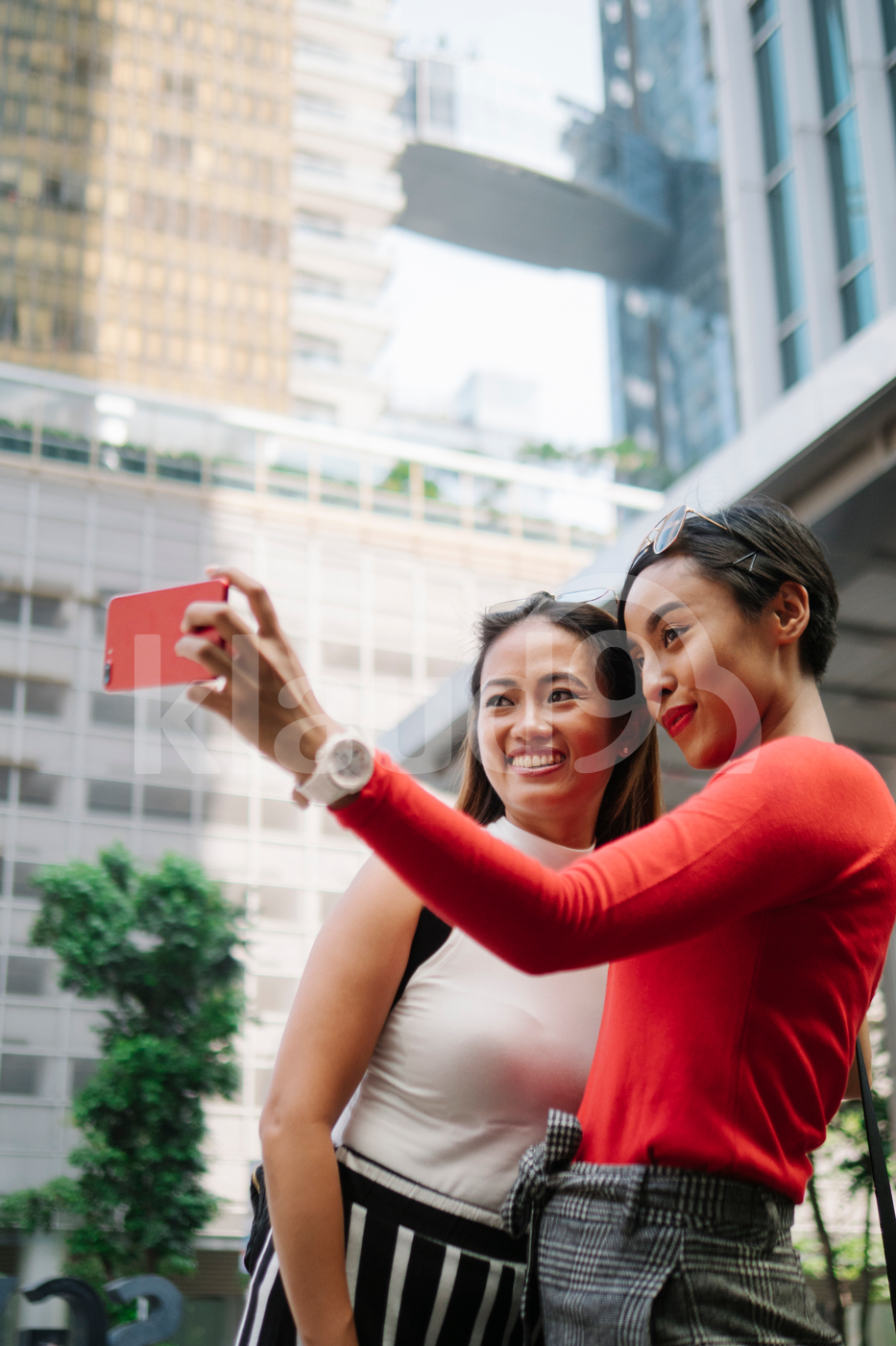 Millennial Asians taking selfie on the street
