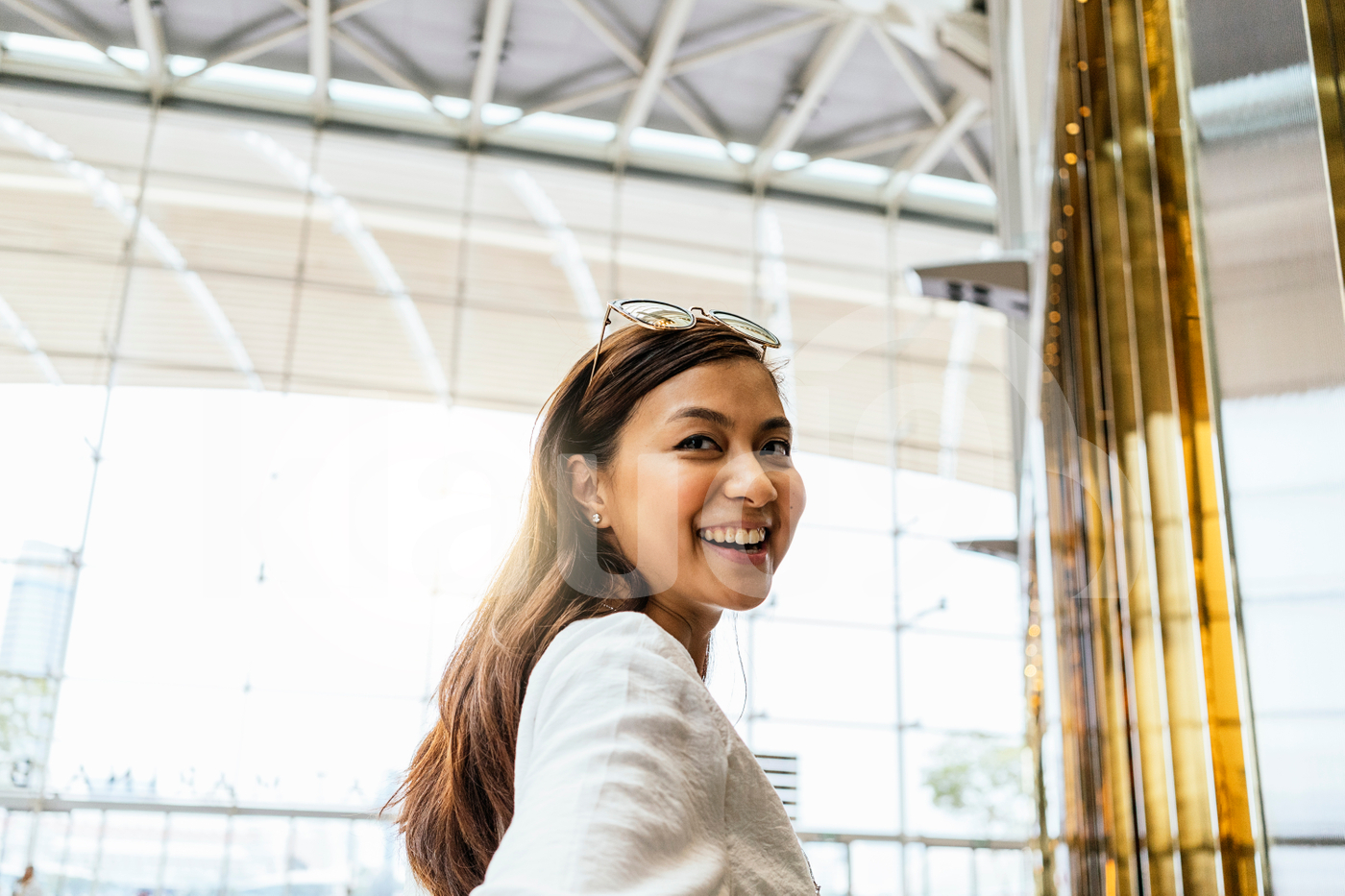 Asian woman standing in the mall and looking at the camera