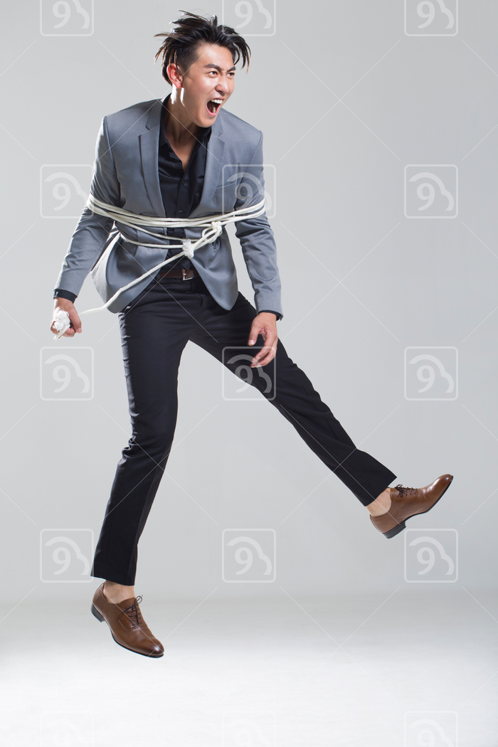 Young Chinese man tied up with rope 