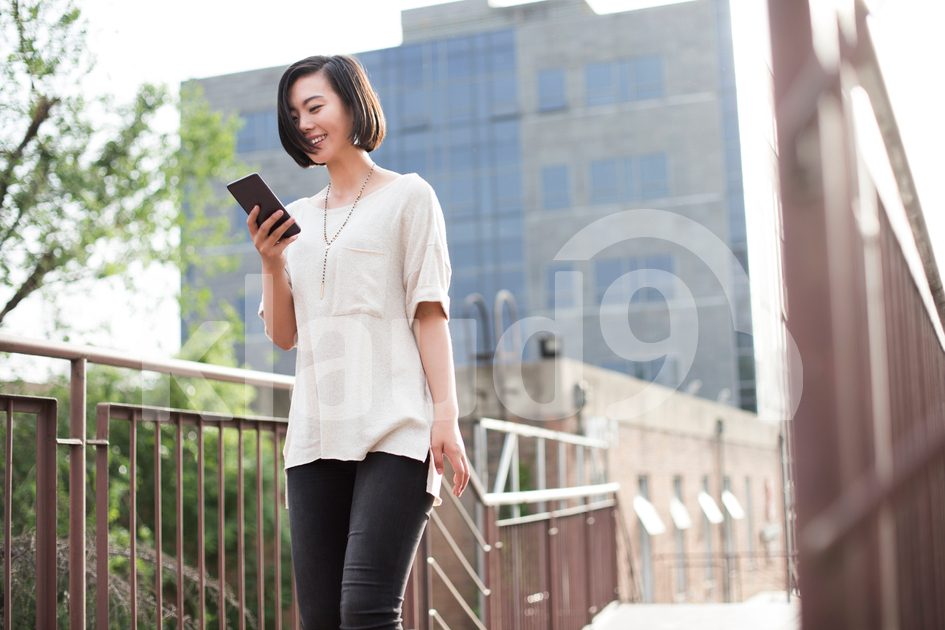 Young Chinese woman using smart phone