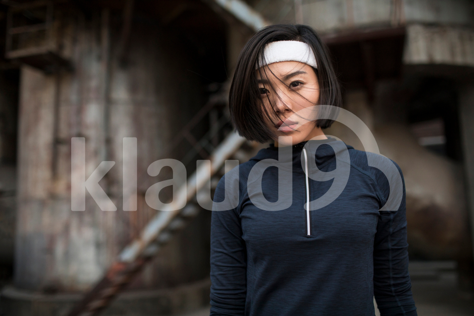 Young Chinese woman resting after running