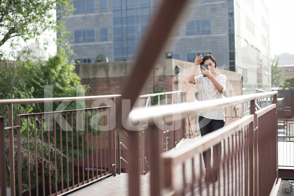 Beautiful young Chinese woman holding a smart phone