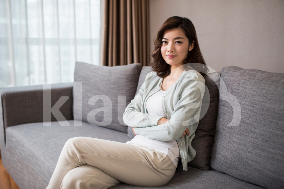 Young Chinese woman relaxing on sofa