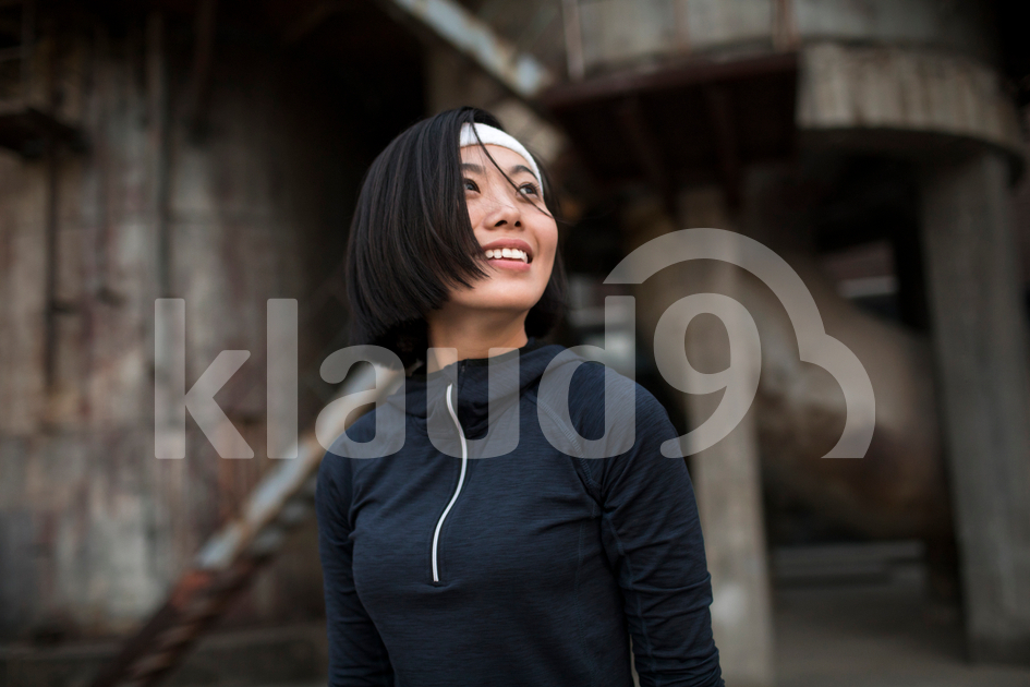 Young Chinese woman resting after running