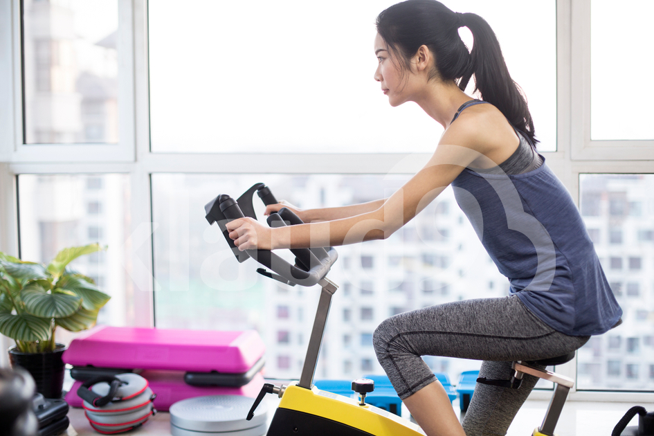 Young Chinese woman exercising at gym