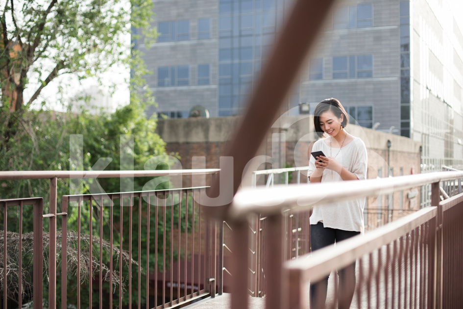 Young Chinese woman using smart phone