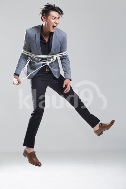Young Chinese man tied up with rope