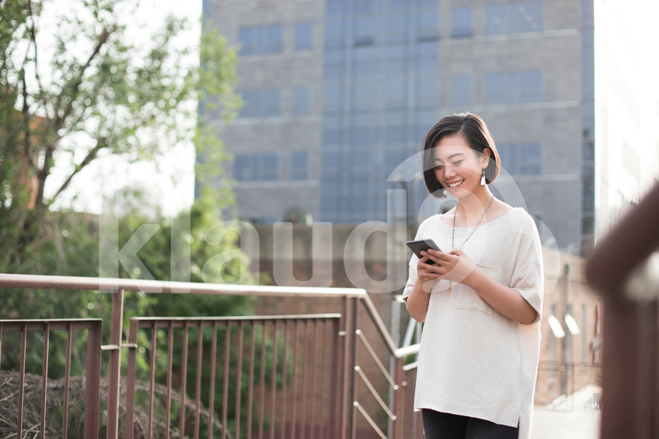 Young Chinese woman using smart phone