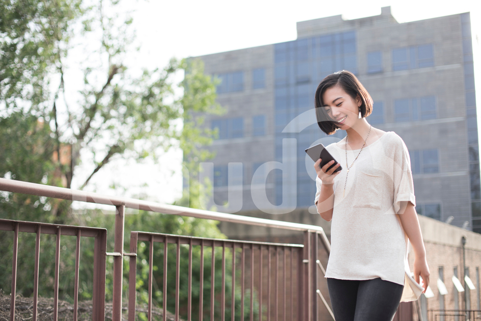 Young Chinese woman using smart phone