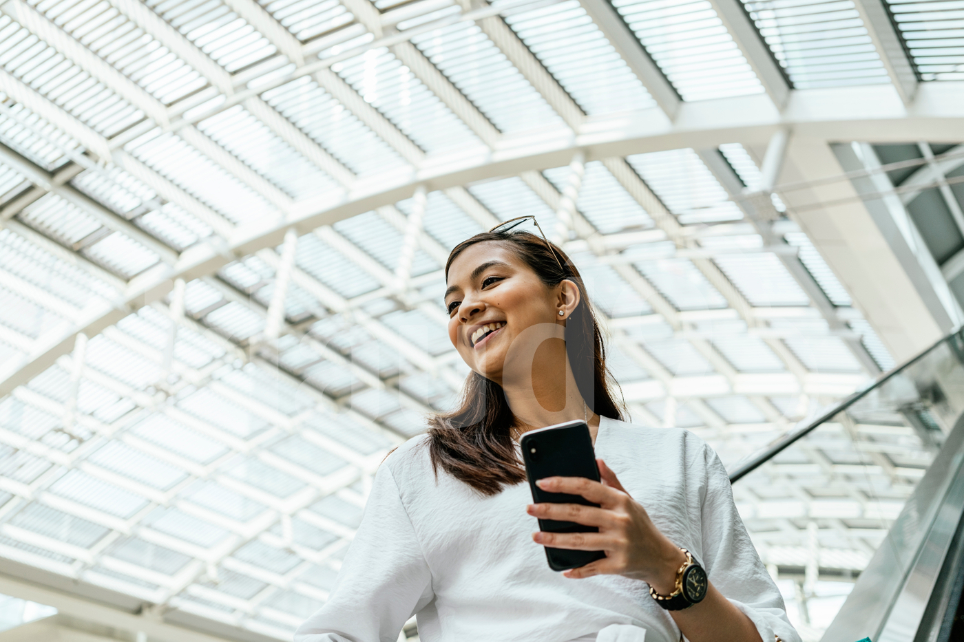 Asian woman in the mall holding a mobile