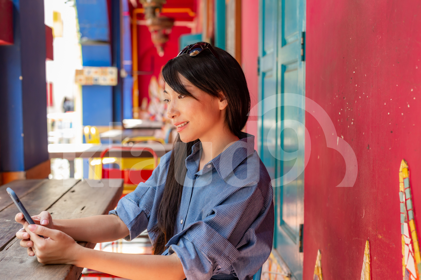 Young Asian woman sitting outdoors