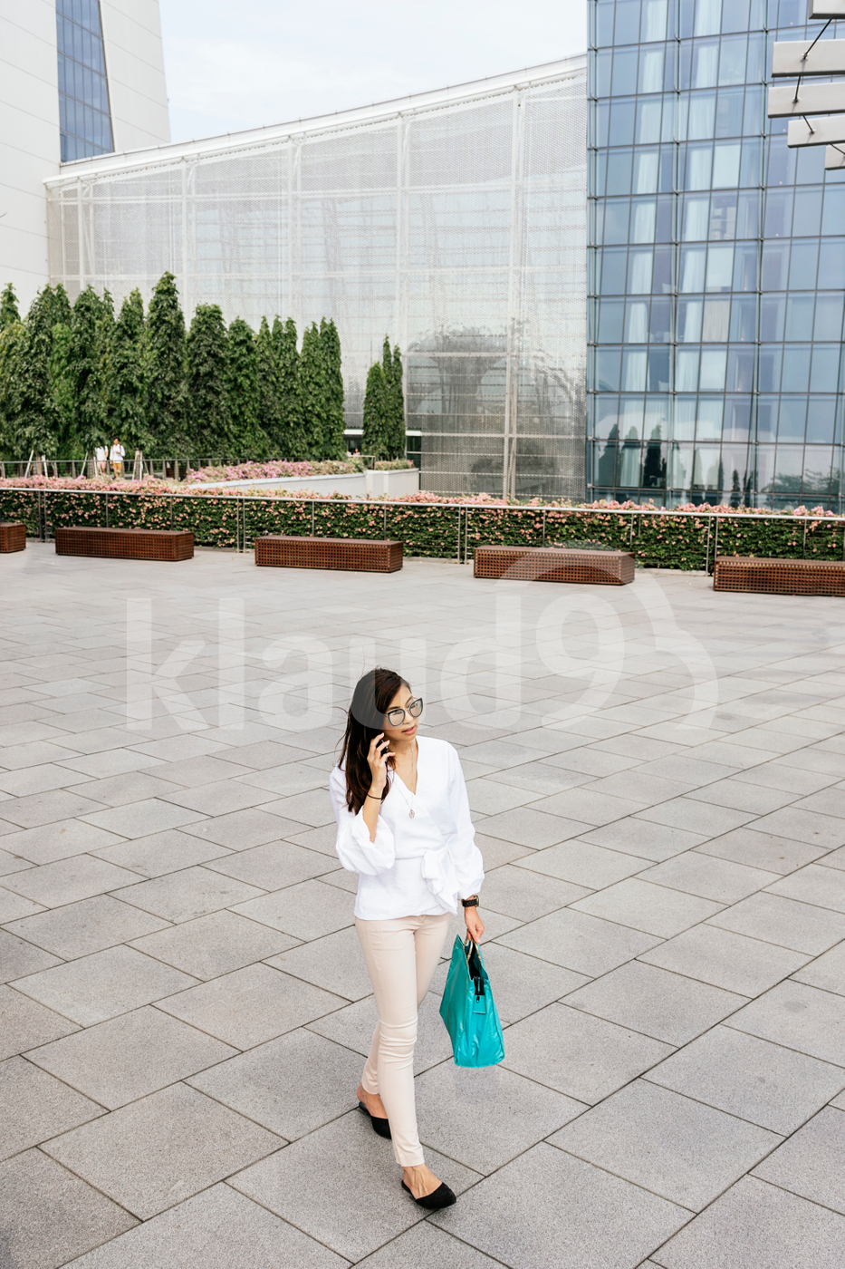 Woman walking down the street while talking on the phone